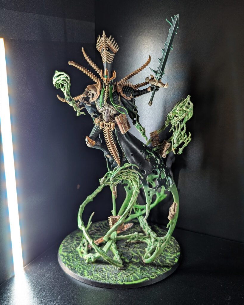 Two completed versions of Nagash, each painted with a different interpretation of the same model.